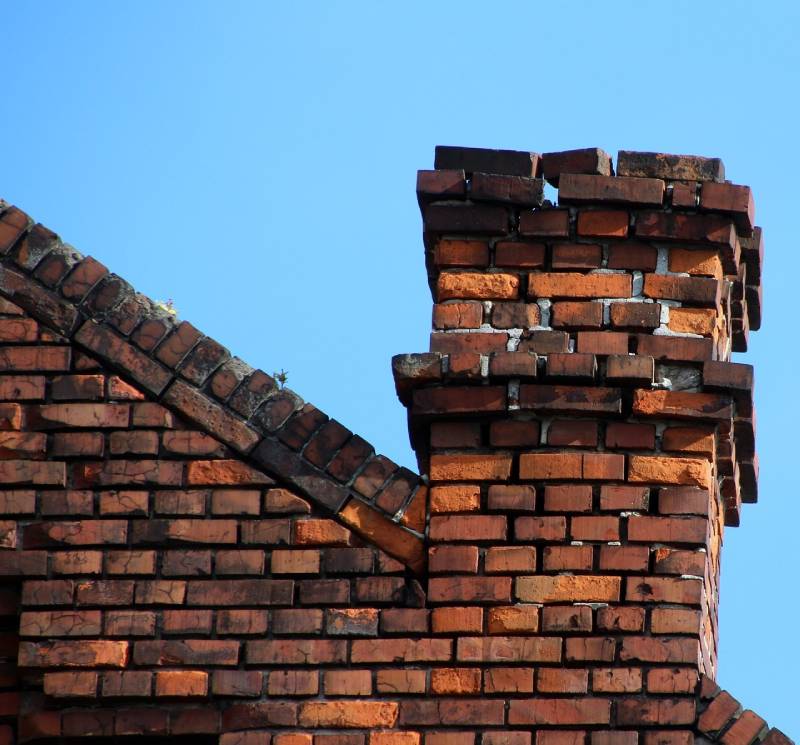 Signs Your Carlisle Home Needs a Chimney Inspection Damaged chimney on an Carlisle home showing cracks and missing mortar